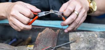Person creating ring with pliers