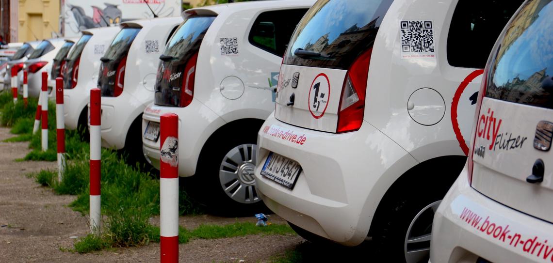 A row of white vehicles parked in a lot.