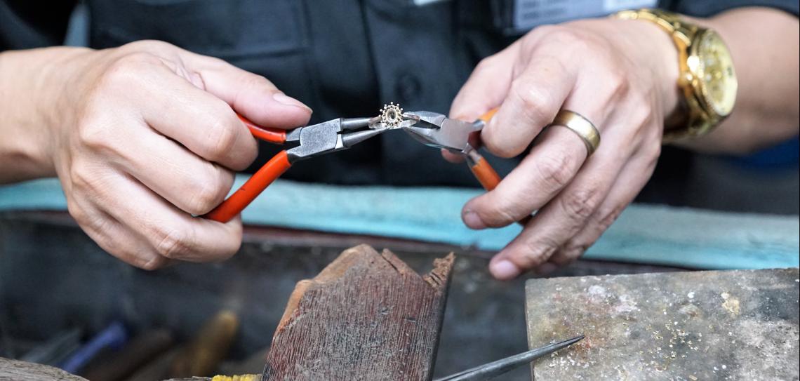 Person creating ring with pliers