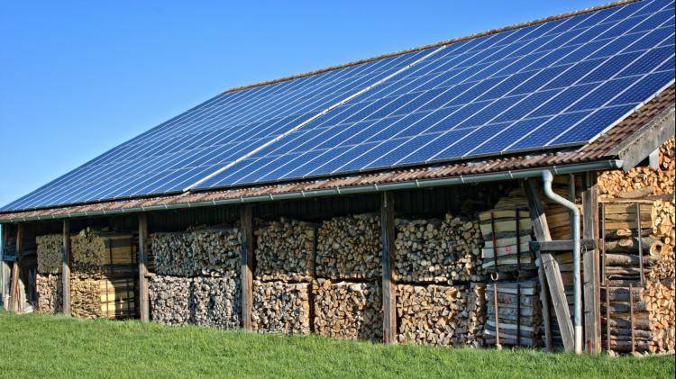 Wood Shed With Solar Panels Attached To Roof